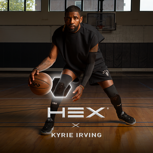 Person holding a basketball on a gym floor with 'HEX x Kyrie Irving' branding.