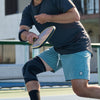 Lifestyle Image of Pickleball Player Wearing McDavid Knee Sleeve/4-Way Elastic