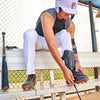 Youth Baseball Player Putting on the McDavid HEX® High Impact Leg Guard