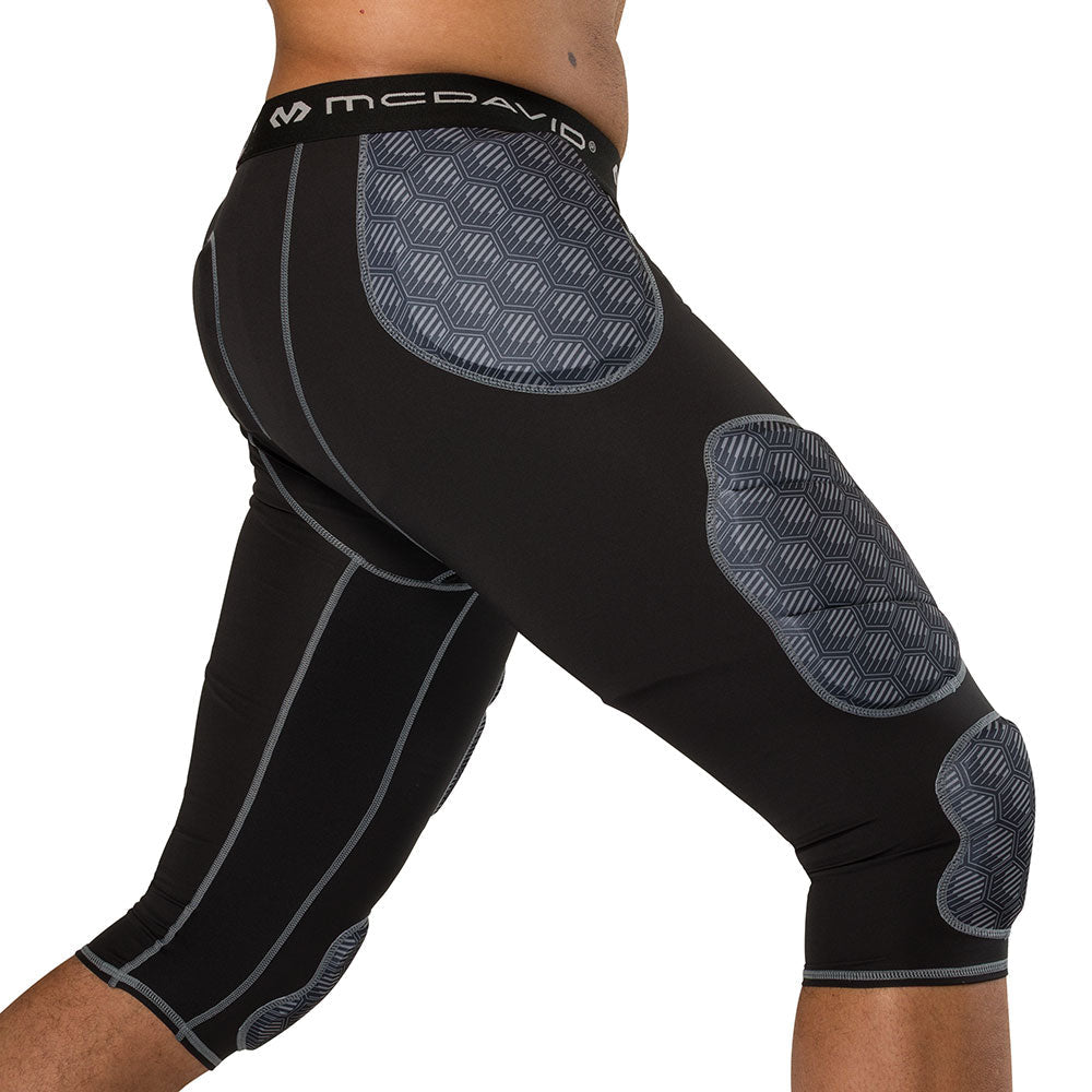 McDavid Rival Integrated 7-Pad ¾ Tight in black, three-quarter side view on model showing hip, thigh and knee pad placement