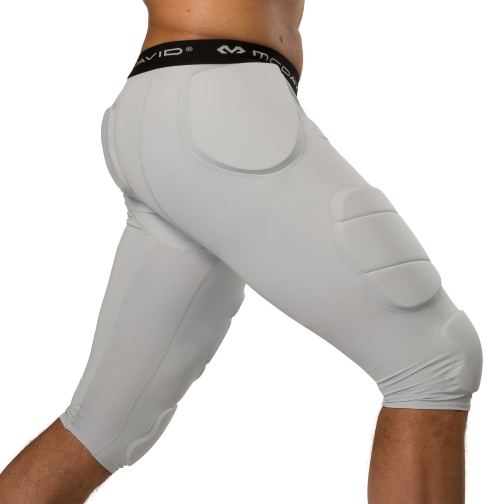 McDavid Rival Integrated 7-Pad ¾ Tight in grey, three-quarter side view on model showing hip, thigh and knee pad placement