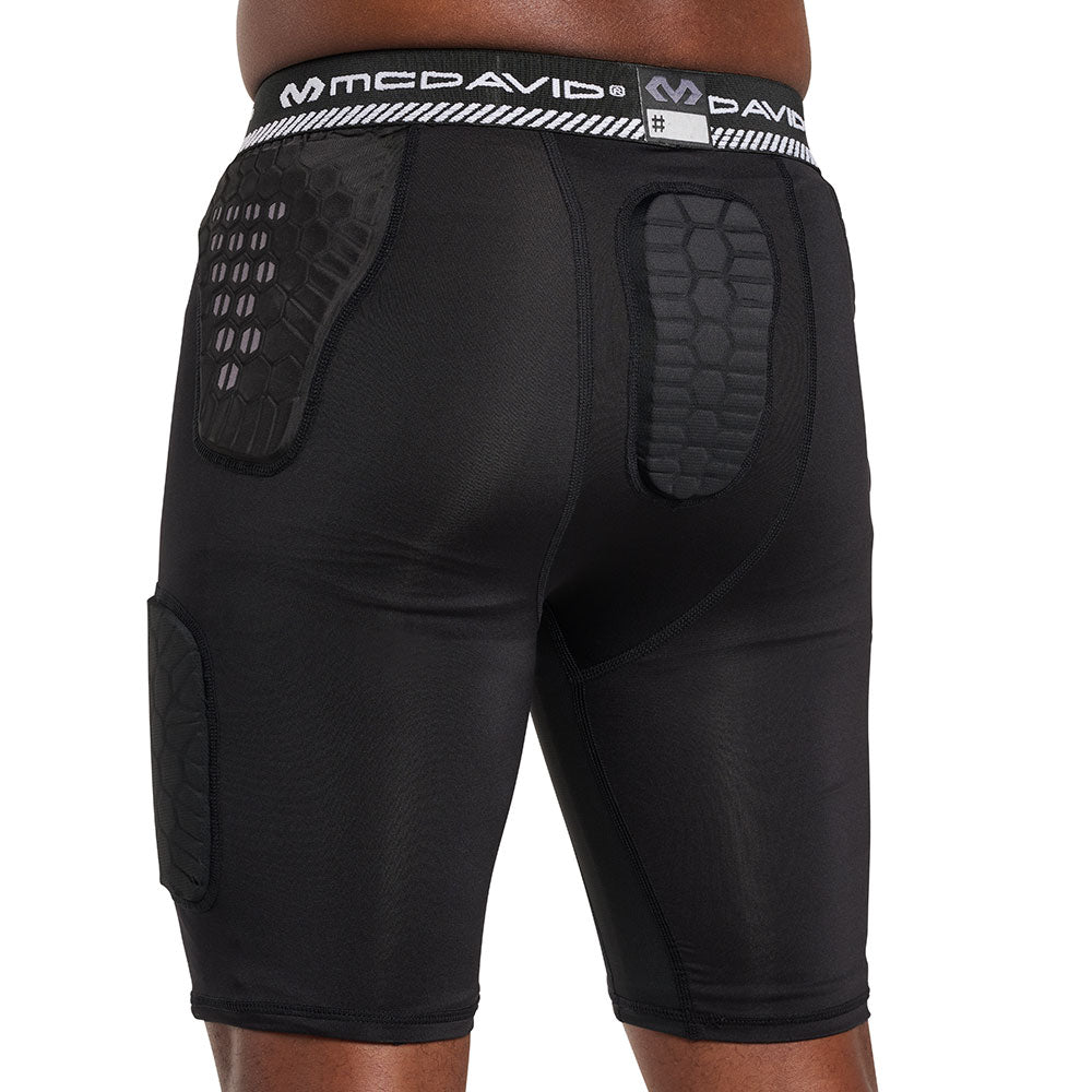 Back view of McDavid HEX® Viz 5-Pad Black Short on model, showing hex-pattern hip and tailbone pads with McDavid logo waistband