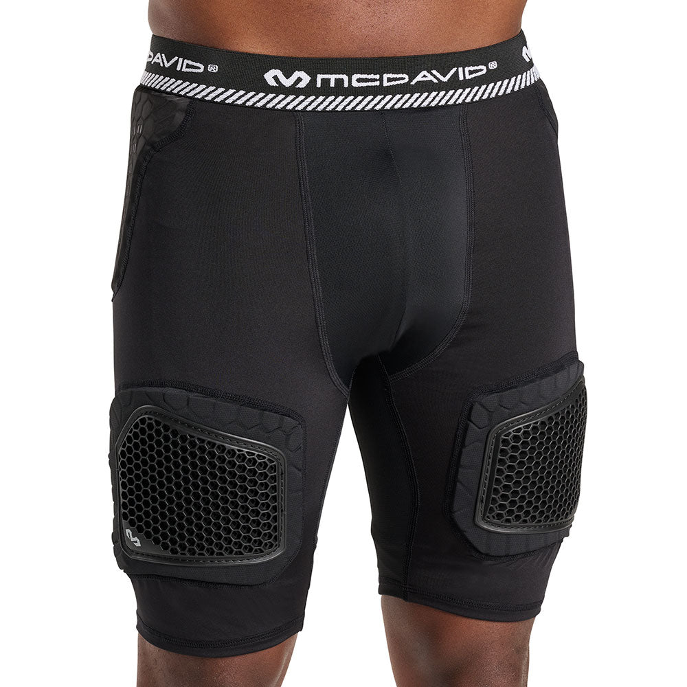 Front view of McDavid HEX® Viz 5-Pad Short with Hard Cap on model, black, showing hip pad placement and hard-shell thigh caps