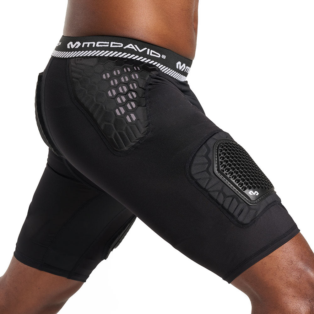 Side view of McDavid HEX® Viz 5-Pad Short with Hard Cap on model, black, showing hip pad and thigh cap placement