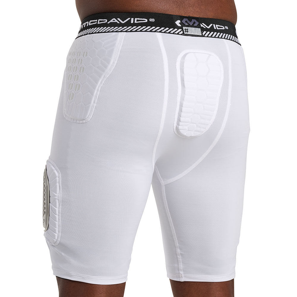 Back view of McDavid HEX® Viz 5-Pad Short with Hard Cap on model, white, showing hex-pattern hip and tailbone pads with McDavid logo waistband
