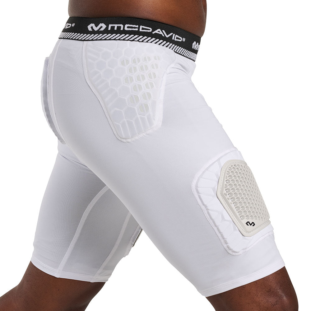 Side view of McDavid HEX® Viz 5-Pad Short with Hard Cap on model, white, showing hip pad and thigh cap placement
