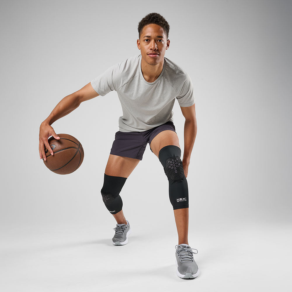 McDavid HEX Viz Leg Sleeve Pair - Black/Grey - Model Wearing Sleeves on Both Legs Playing Basketball