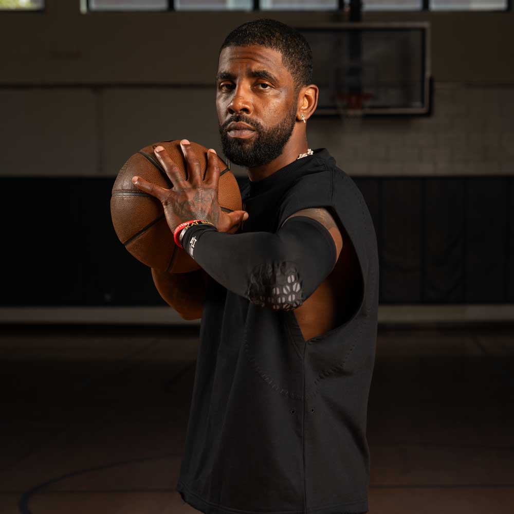 Kyrie Irving, Top NBA Basketball Start, wearing HEX® Viz Arm Sleeve/Single while Holding Basketball