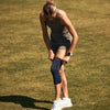 McDavid Infused Therapy Buttersoft Knee Sleeve - Athlete Putting on Knee Sleeve