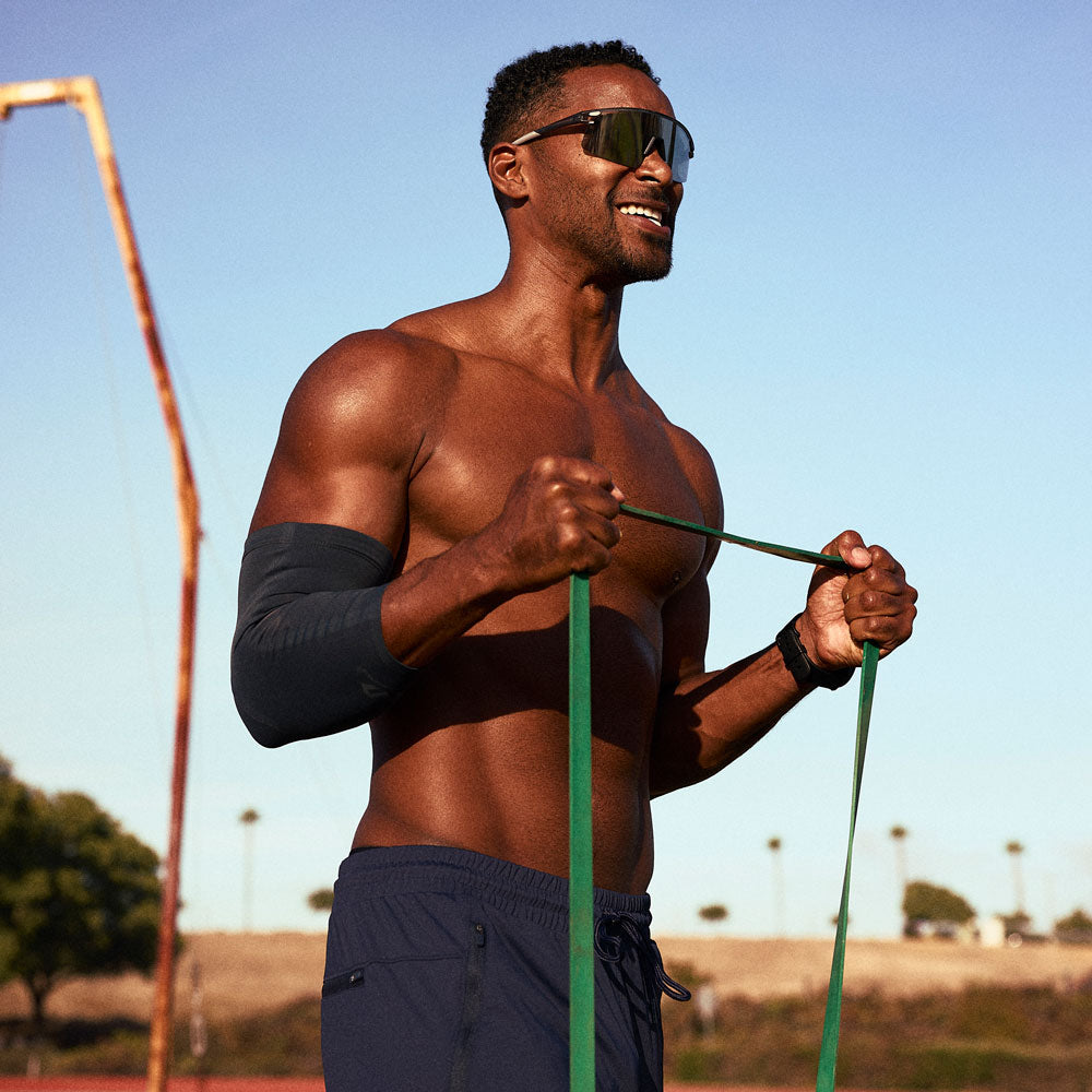 McDavid Infused Therapy Buttersoft Elbow Sleeve - Athlete exercising while wearing elbow sleeve 