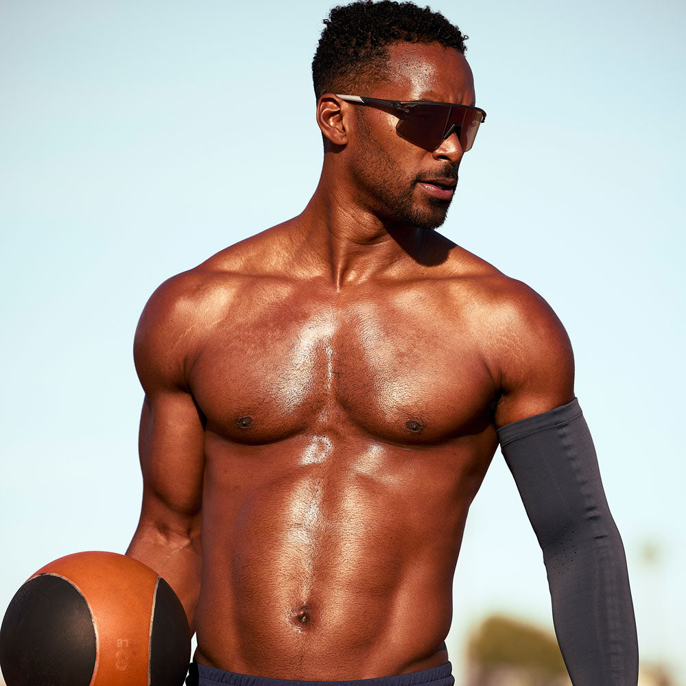 McDavid Infused Therapy Buttersoft Arm Sleeve - Athlete wearing arm sleeve while exercising