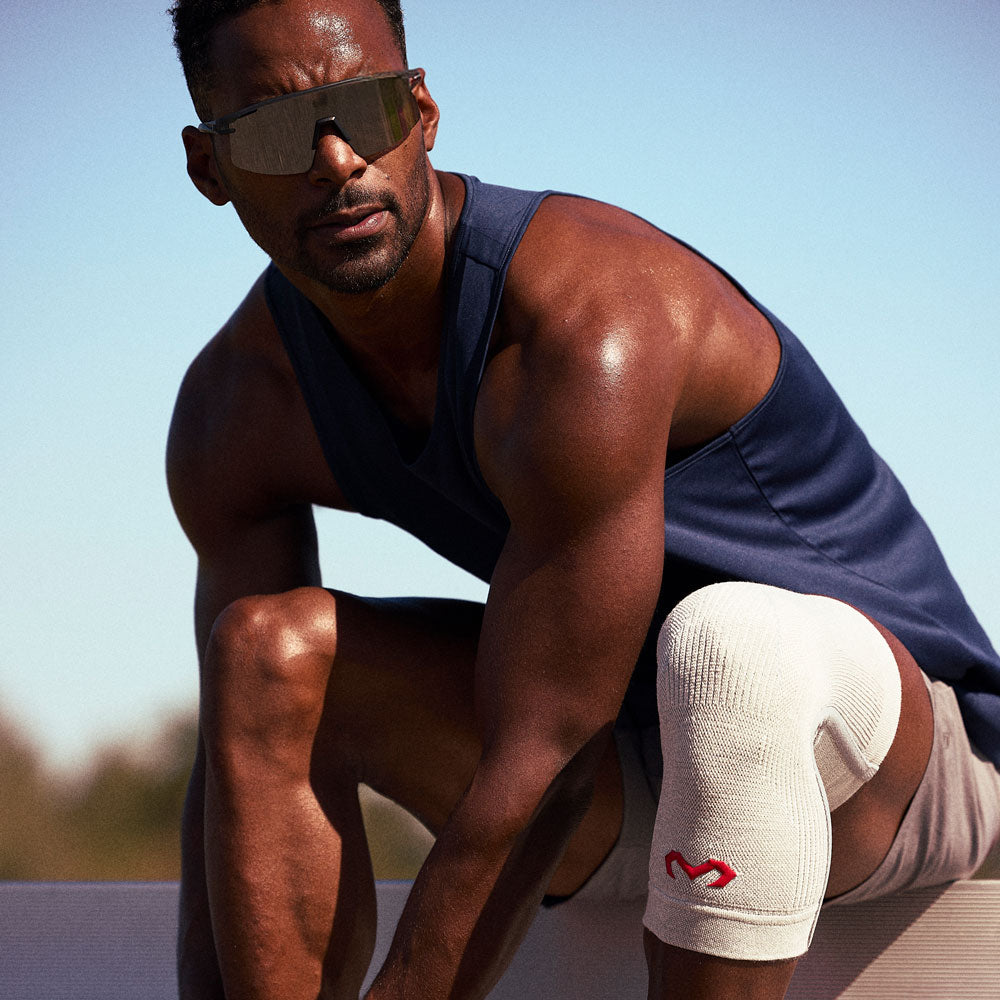 McDavid Infused Knit Knee Sleeve - Grey - Shown on Athlete's Knee While Stretching
