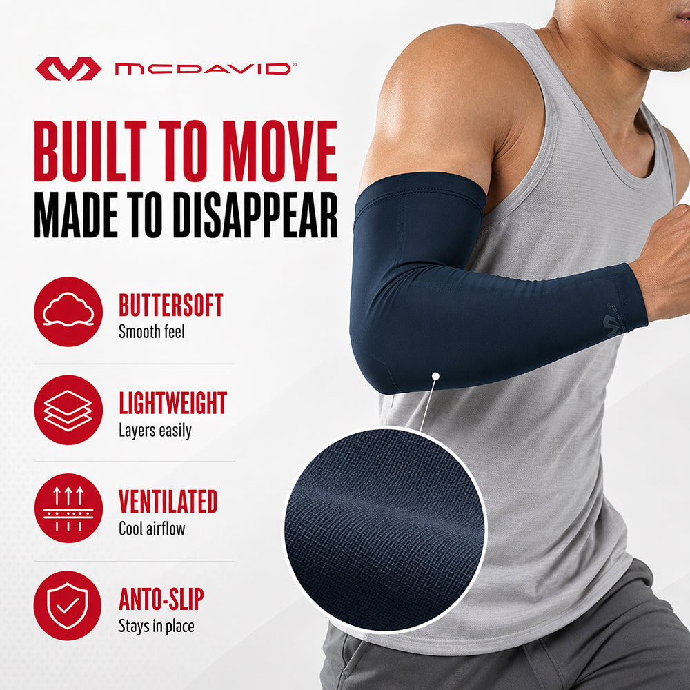 Man running in the Navy McDavid Buttersoft arm sleeve, with a close-up of the fabric. Features include a buttersoft feel, lightweight layering, ventilated airflow, and an anti-slip fit that stays in place.