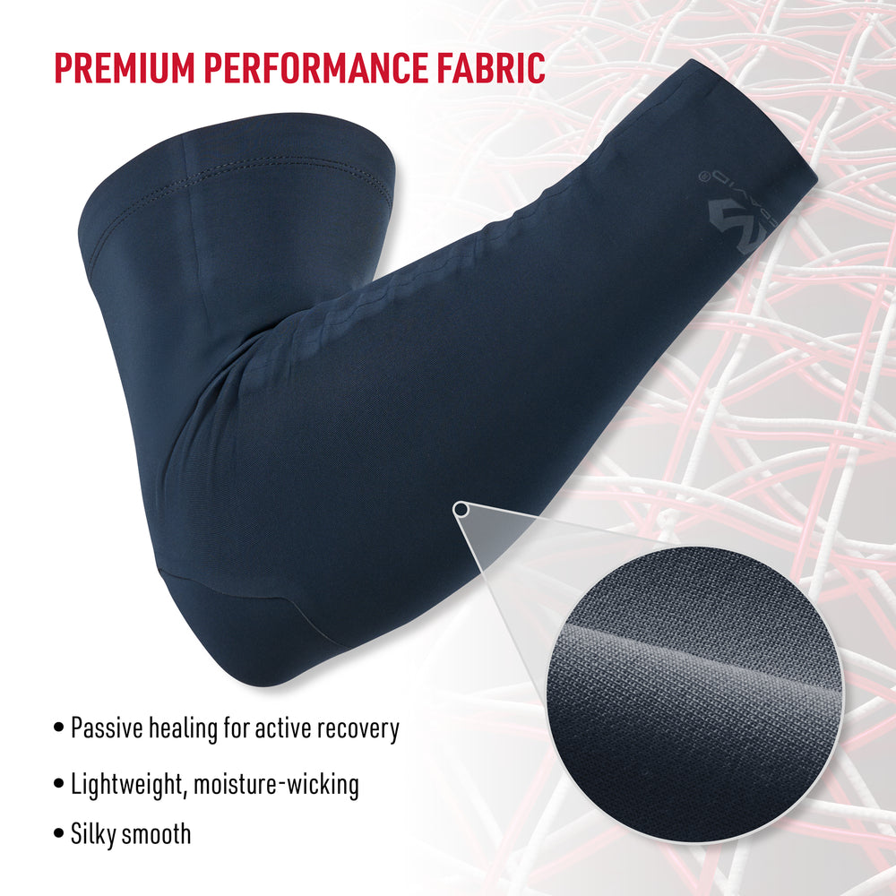 Close-up of navy Infused Buttersoft arm sleeve showing premium performance fabric with texture detail, highlighting passive healing, lightweight moisture-wicking, and silky smooth feel