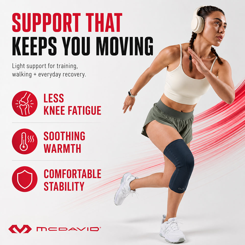 Woman running in the Navy McDavid Buttersoft knee sleeve. It gives light support for training, walking, and everyday recovery, with less knee fatigue, soothing warmth, and comfortable stability.