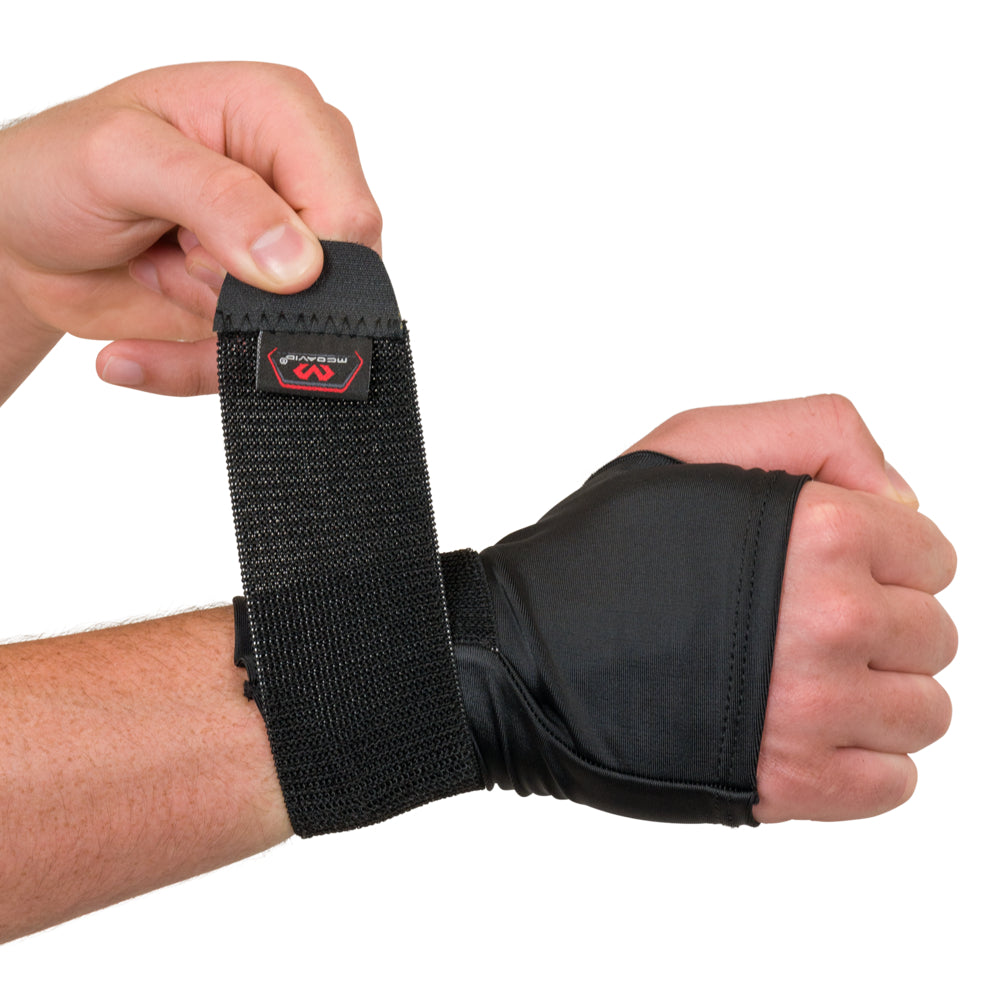 Close-up of the adjustable strap being wrapped and fastened on the compression wrist sleeve