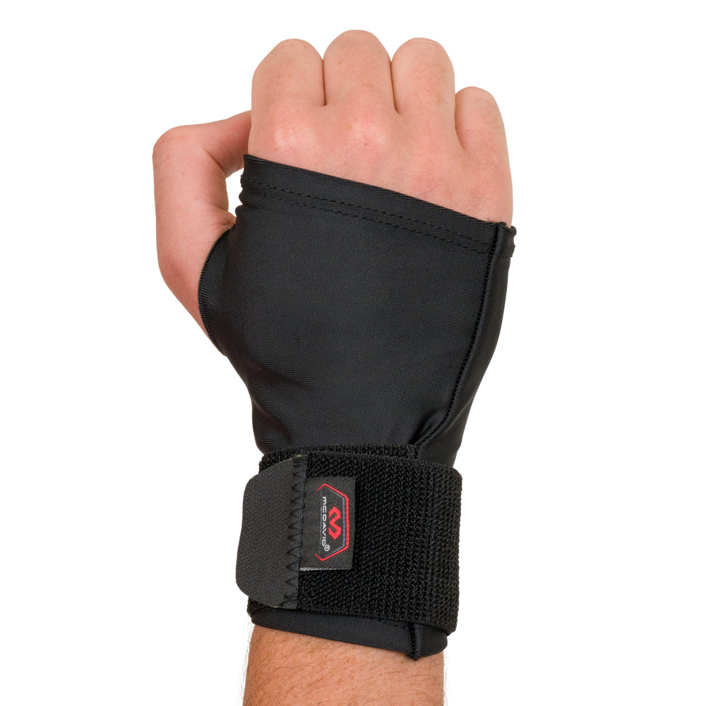 McDavid compression wrist wrap worn on the hand with the adjustable strap secured around the wrist