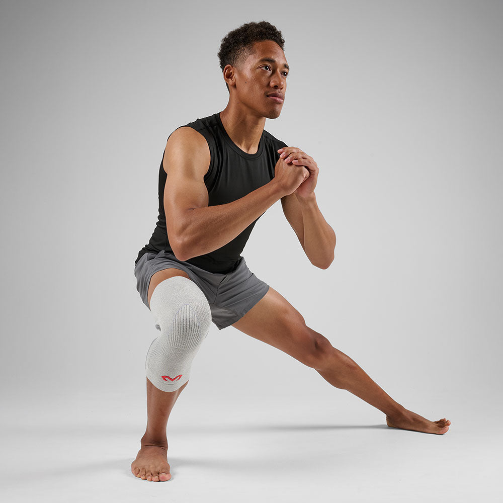 McDavid Infused Knit Knee Sleeve - Grey - Shown on Model's Knee while Stretching