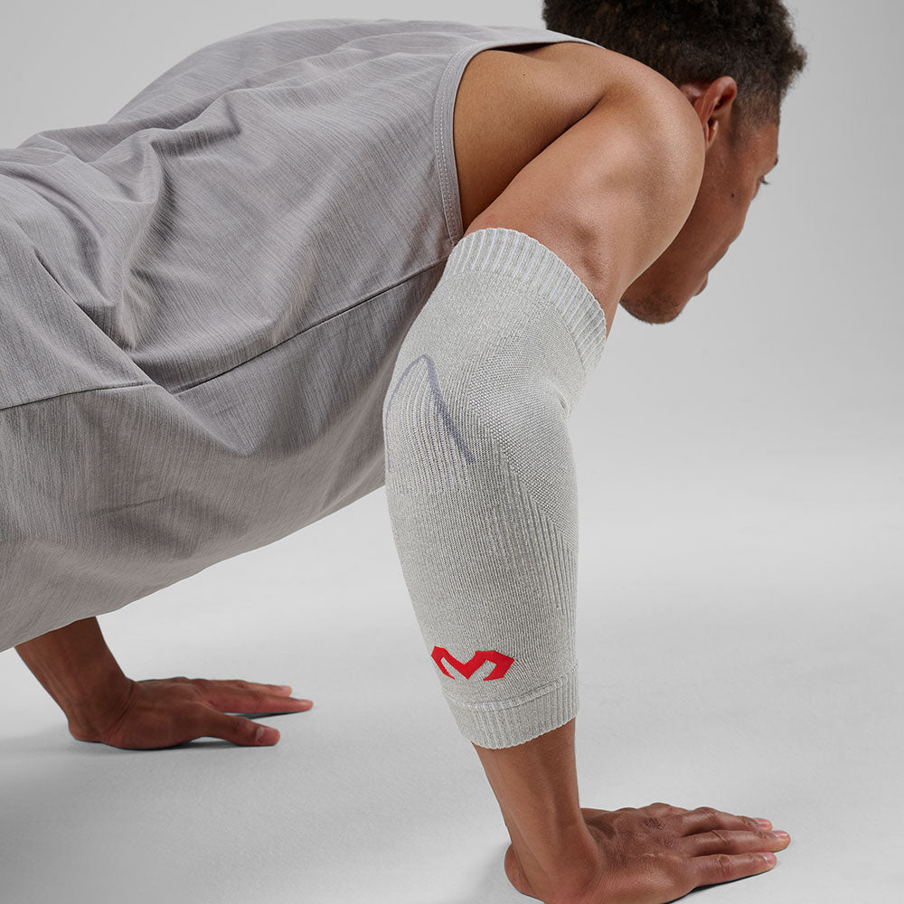 McDavid Infused Knit Elbow Sleeve - Grey- Shown on Model's Elbow while Exercising