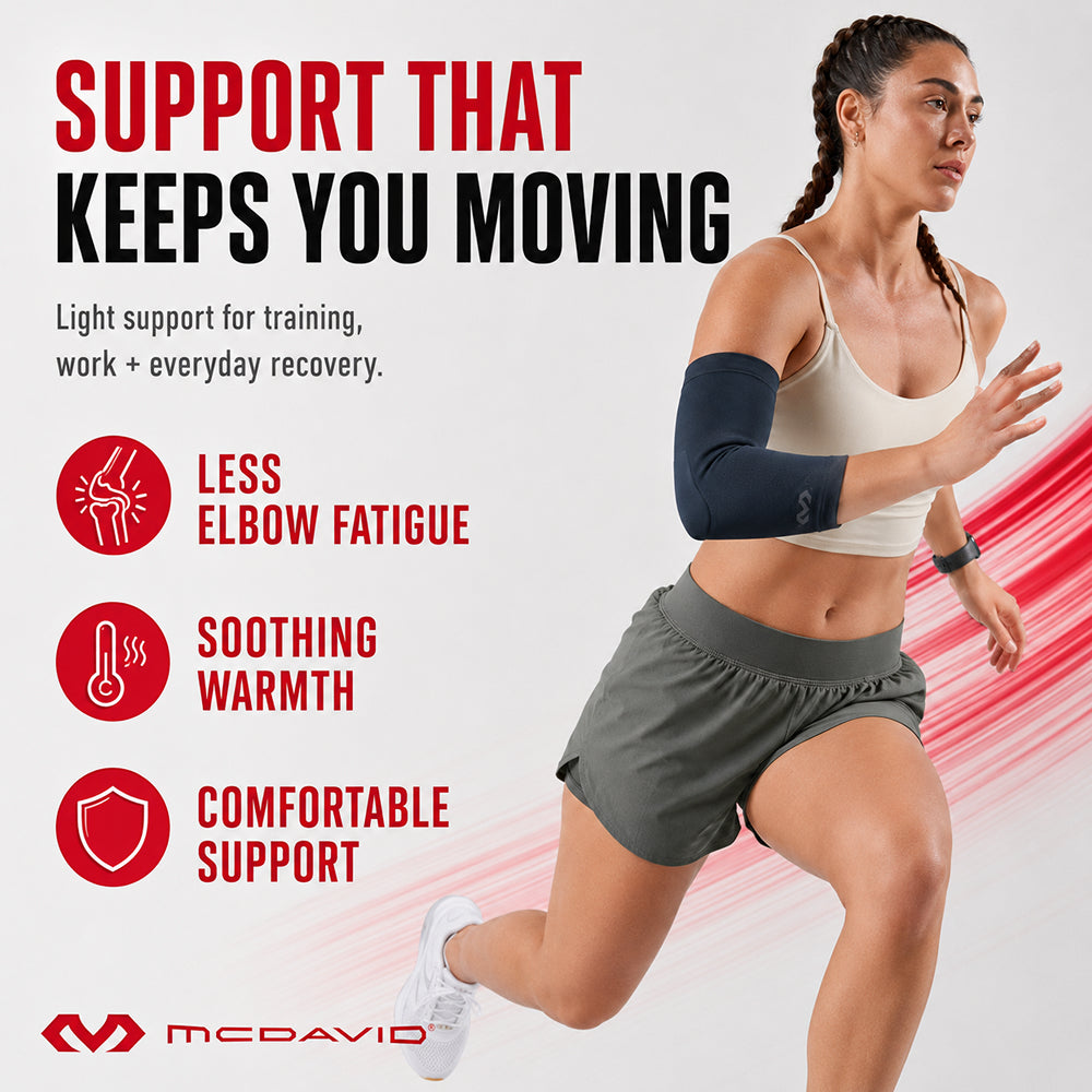Woman running in the Navy McDavid Infused Therapy Buttersoft elbow sleeve. It gives light support for training, work, and everyday recovery, with less elbow fatigue, soothing warmth, and comfortable support.