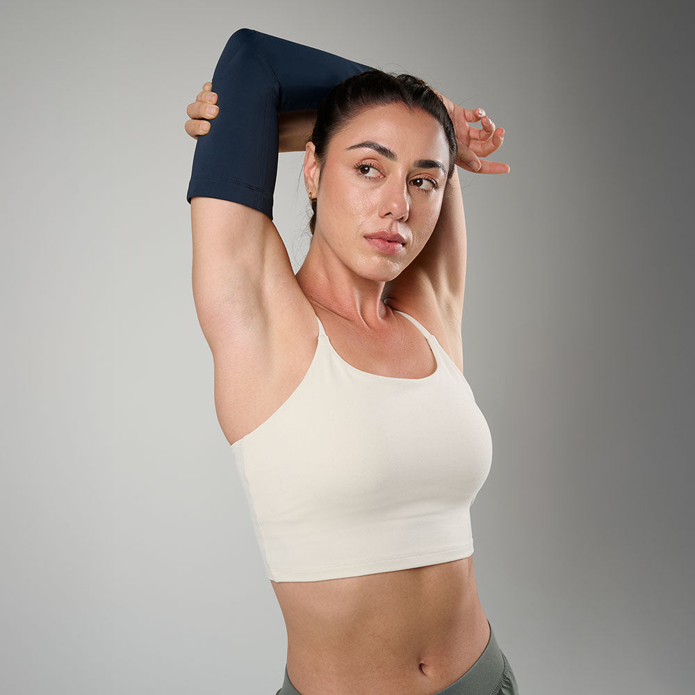 McDavid Infused Therapy Buttersoft Elbow Sleeve - Athlete stretching arms while wearing elbow sleeve 