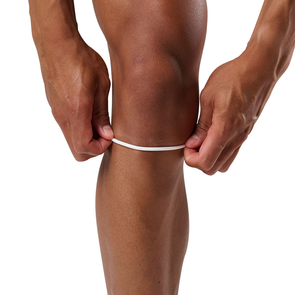 McDavid Silicone Patella Band Pair - White - Shown on Model Pulling Up Band on Knee