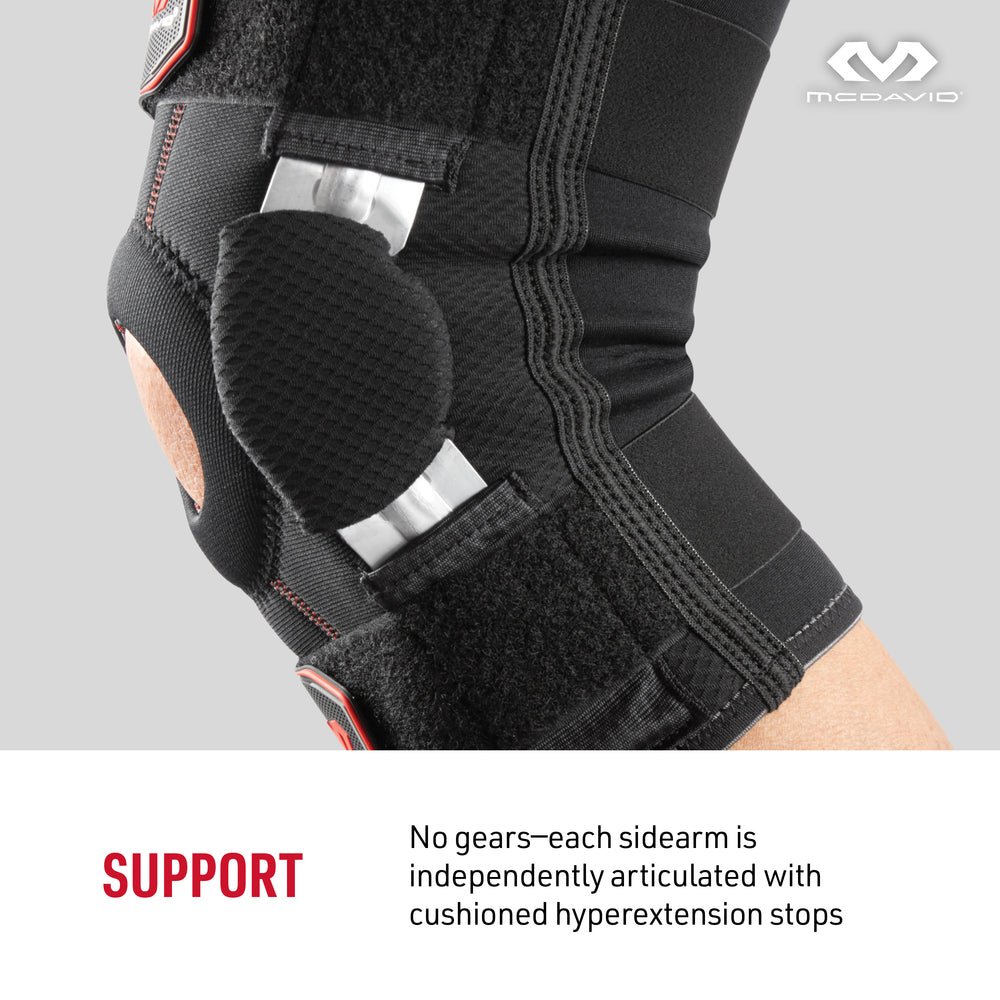 Close-up of the McDavid Knee Brace with Dual Disk Hinges side hinge, showing the independently articulated sidearm with cushioned hyperextension stop.