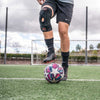 Soccer Player Wearing McDavid Knee Support with Stays & Cross Straps