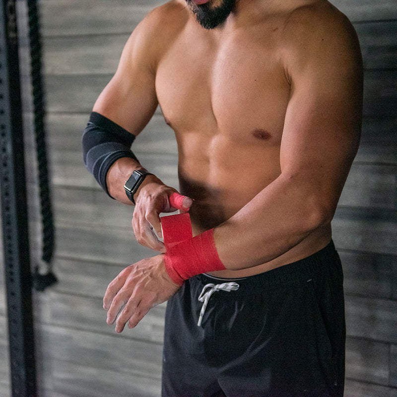 Male Crossfit Athlete Wearing McDavid Athletic Tape (Red) to Wrap Wrist and Thumb