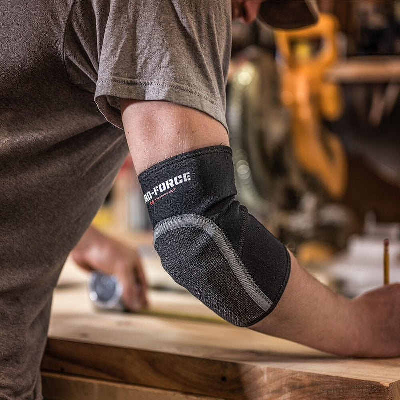 Contractor Using Tape to Mark Length on a Work Bench Wearing the Neoprene Elbow Sleeve with Abrasion Patch