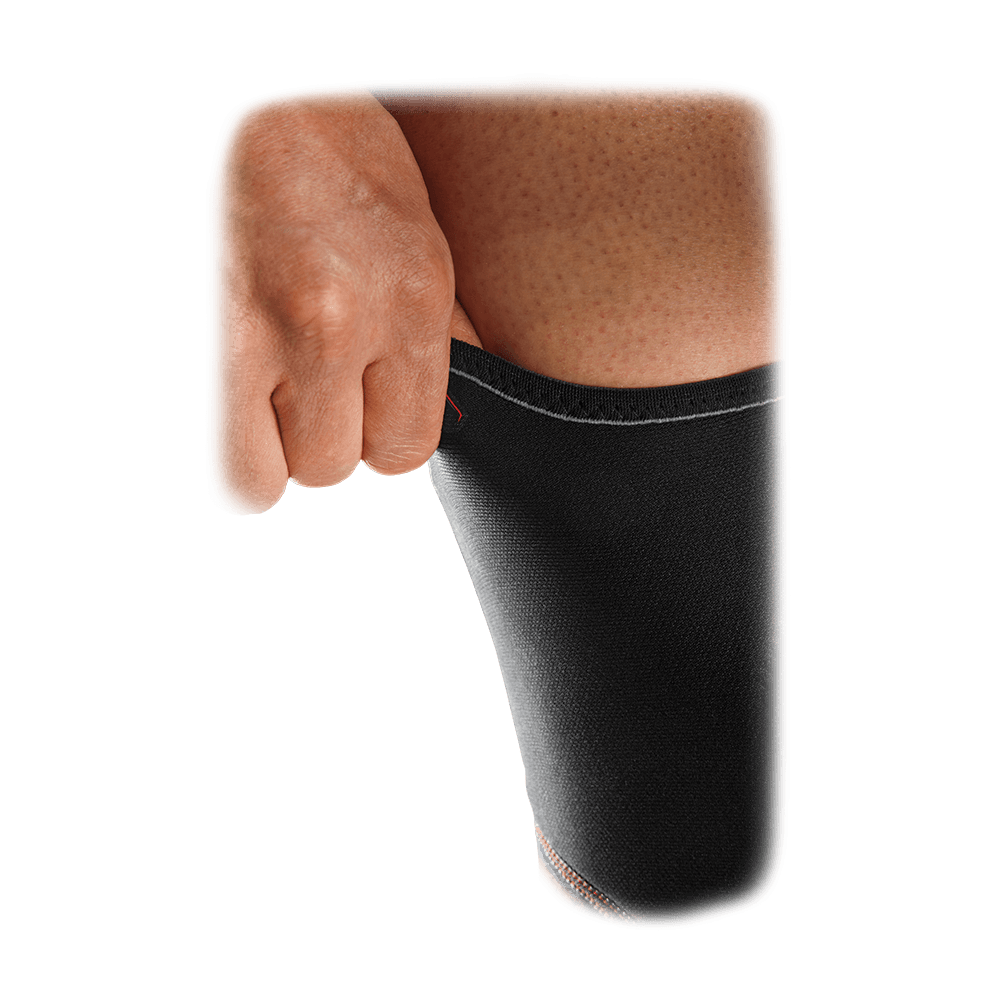 McDavid Knee Sleeve with Open Patella in black being pulled over the knee